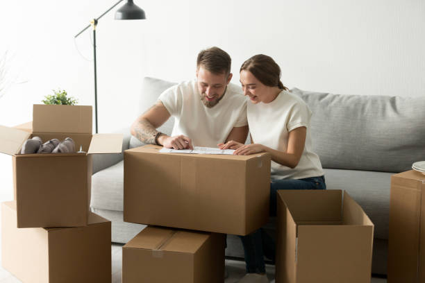 istock Happy smiling couple discussing house architectural plan 1070060936