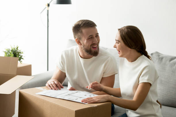 istock Happy laughing couple discussing house architectural plan 1070061004