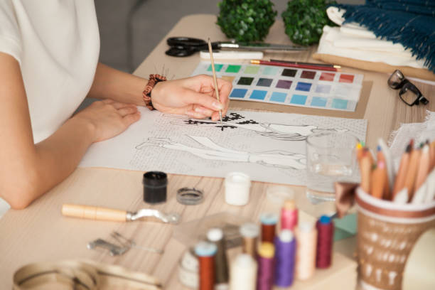 istock Female clothing designer sketching with brush at workplace 1070061232