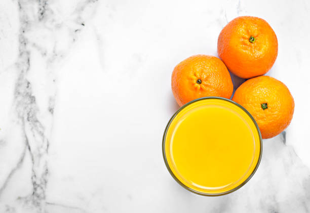 istock Fresh orange juice in a drinking glass 1070062098