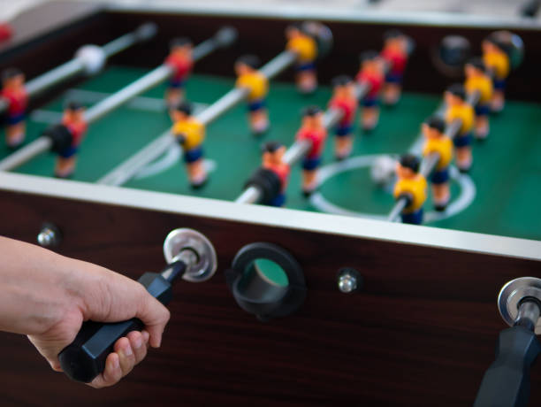 istock wooden table with football game 1070063108