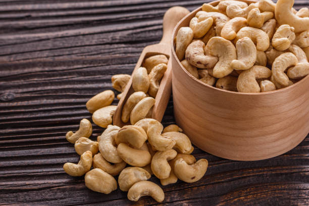 istock cashew nuts on a rustic wooden background 1070063264