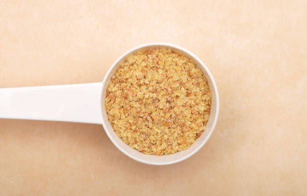 istock Wheat germs in measuring spoon on brown background 1070063426
