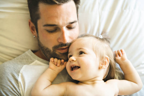 istock Father and his baby daughter on bed having fun 1070066008