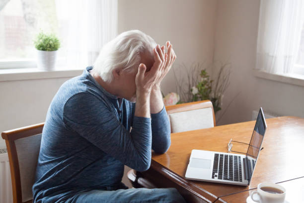 istock Tired senior man suffering from headache massaging eyes 1070066572
