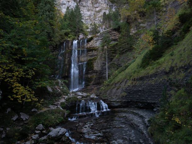 istock Autumn mountain with lake and waterfall 1070066910