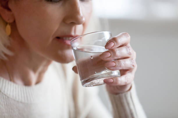 istock Senior woman having pure water feeling dehydrated 1070069300