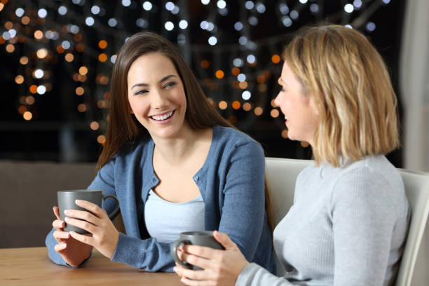 istock Two happy friends talking in the night at home 1070070478