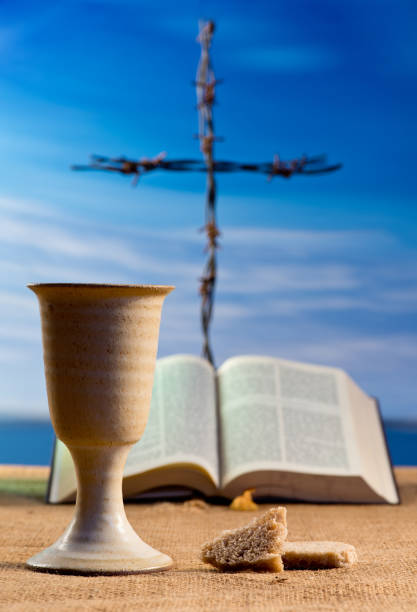 istock Open bible with chalice of wine and cross 1070071680