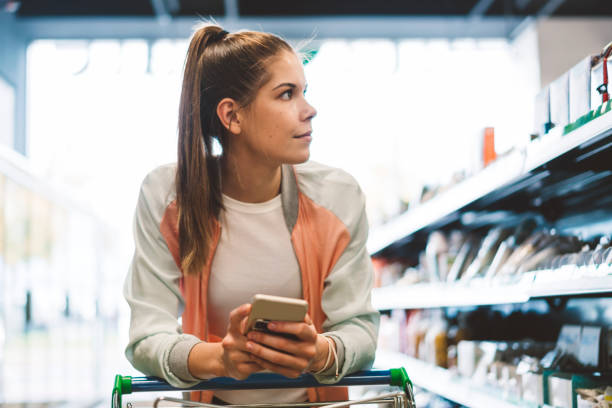 istock Young brunette looking for baking soda at grocery store 1070074194
