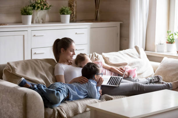 istock Young mother and children using pc have fun at home 1070078978