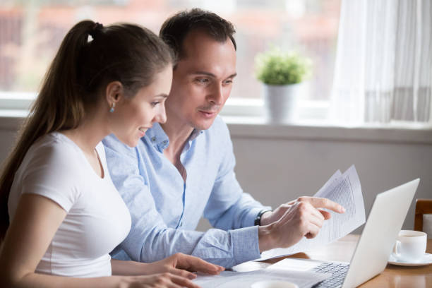 istock Satisfied wife and husband checking bills at home 1070079042
