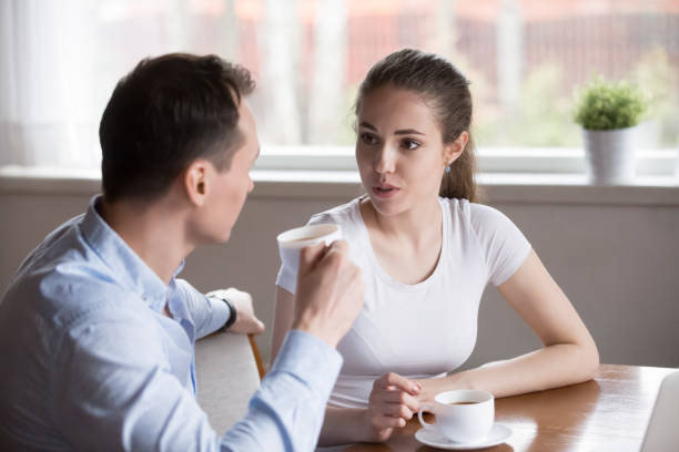 istock Couple talking and drinking morning coffee in the kitchen 1070079196