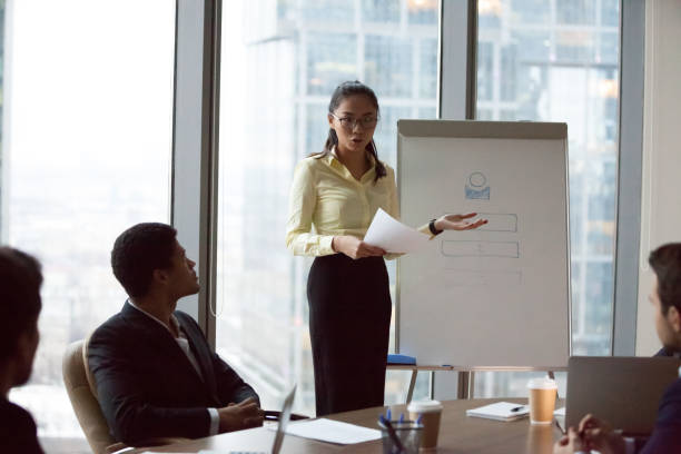 istock Female Asian worker make flipchart presentation at meeting 1070079900