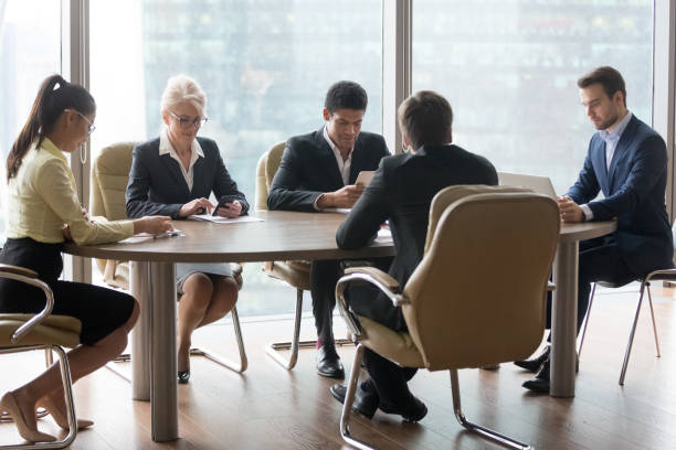 istock Diverse employees using gadgets during business office meeting 1070080032