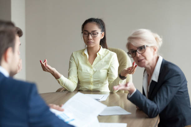 istock Calm female employee meditate at meeting avoiding conflicts 1070080036
