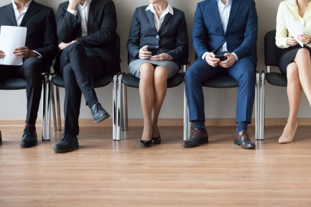 istock Legs of diverse work candidates waiting in turn for interview 1070080092