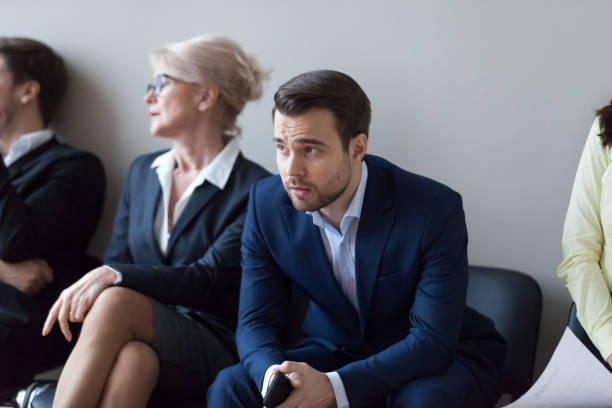 istock Nervous millennial male employee wait in queue for interview 1070080136