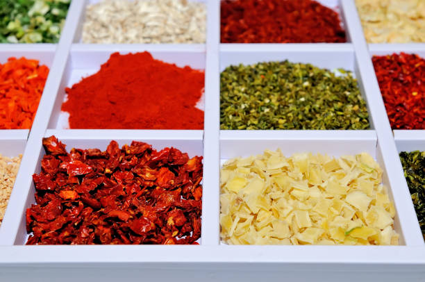 Various types of spices in white wooden boxes