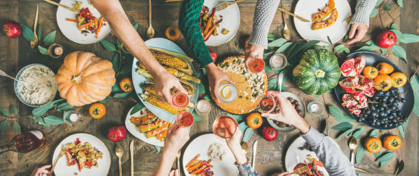 istock Friends clinking glasses at Thanksgiving Day, wide composition 1070085890