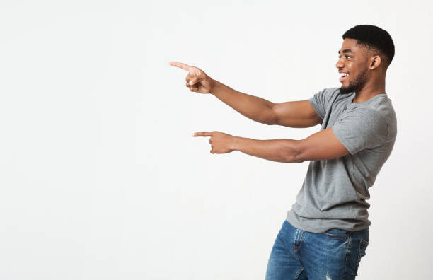 istock Excited black man pointing two fingers aside at copy space 1070087686
