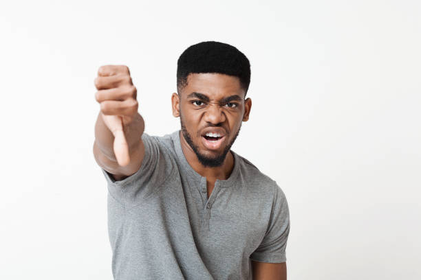 istock Angry man showing thumb down gesture as rejection symbol 1070087744