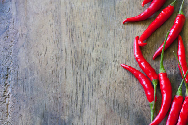 istock red chili on wood background 1070087970