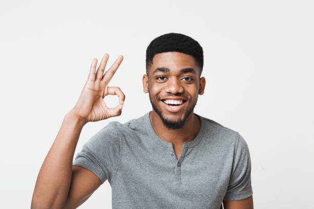 istock Happy black man gesturing OK sign and smiling 1070088656