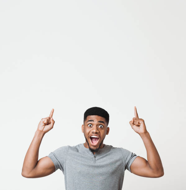 istock Excited african-american man pointing upwards at copy space 1070088992