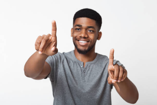 Black man touching on transparent screen interface Innovation in modern life. Happy african-american man touching on transparent screen interface, copy space clicking screen stock pictures, royalty-free photos & images