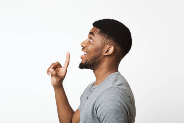 African-american man having idea, pointing with finger and looking up
