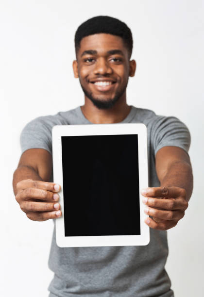 istock African-american man showing blank digital tablet screen 1070089400