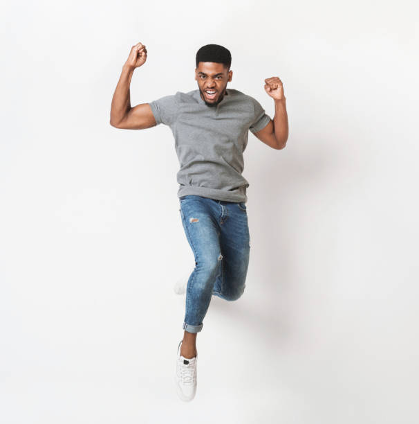 istock Young black man jumping against white background 1070089488