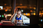 Teenage girl doing homework at night