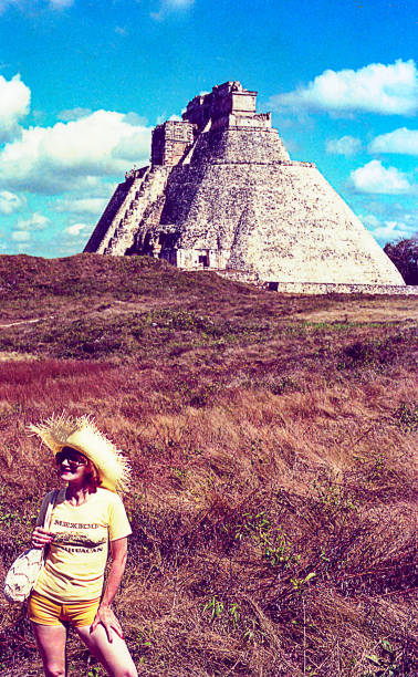 Woman visiting ancient Mexican ruins Vintage image of a Woman climbing an ancient Mexican ruin yucatan photos stock pictures, royalty-free photos & images