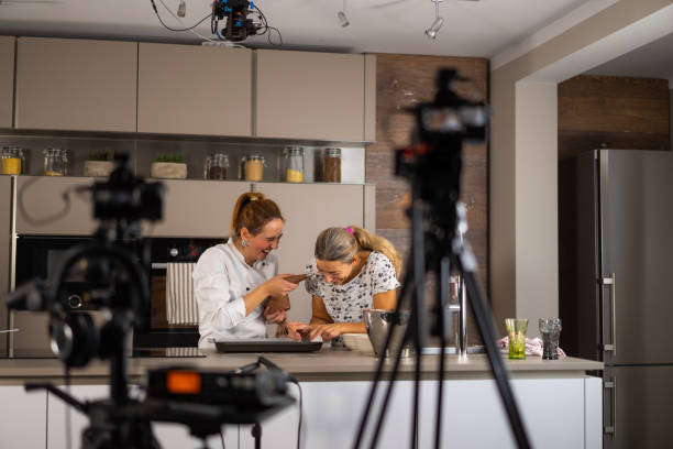 istock female cook and film making assistant having fun on set in kitchen 1070097700