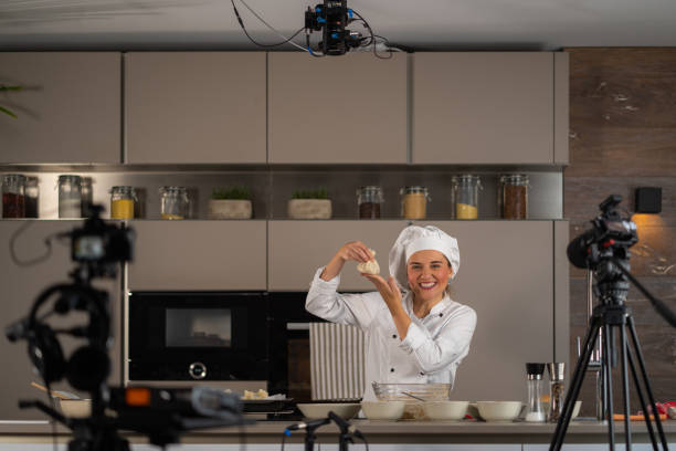 istock happy smiling female cook in tv studio kitchen 1070097714