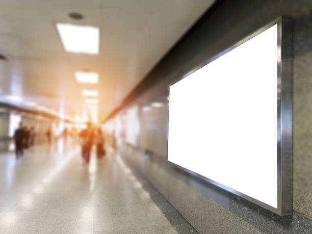 istock billboard big blank white LED screen perspective horizontal outstanding in subway side pathway people walking to train underground for display advertisement text template promotion new brand indoor. 1070097784