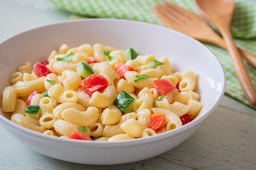 Macaroni salad with elbow pasta and vegetables in bowl