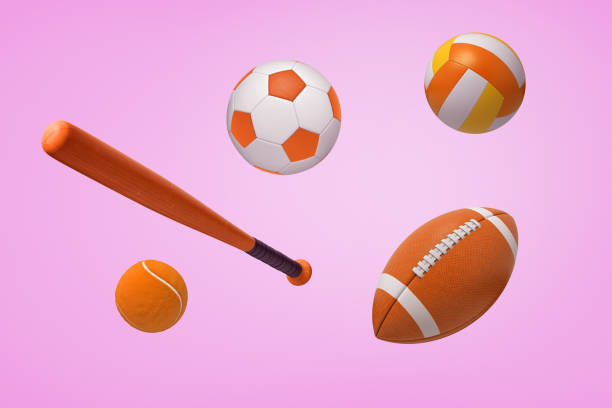 renderização 3d de várias bolas laranja para futebol, futebol americano e tênis, com um taco de baseball em um fundo rosa. - three dimensional three dimensional shape american culture usa - fotografias e filmes do acervo