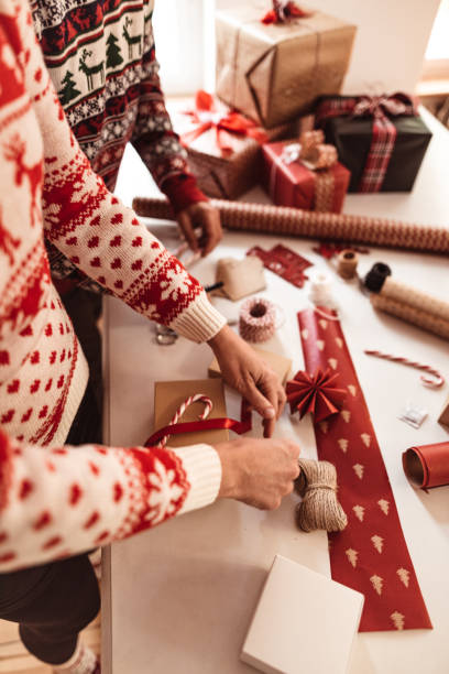 istock couple preparing the packages for christmas 1070105582