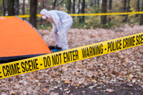 istock Crime scene tape in the woods. 1070109476