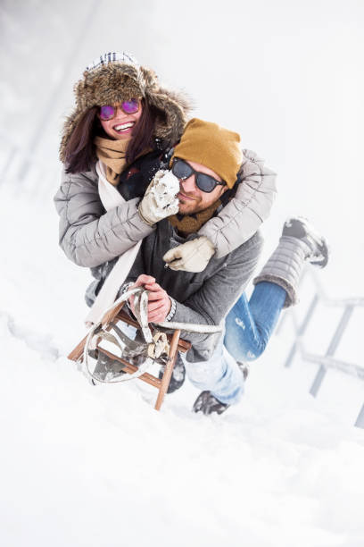 istock Young couple having fun in snow 1070113826