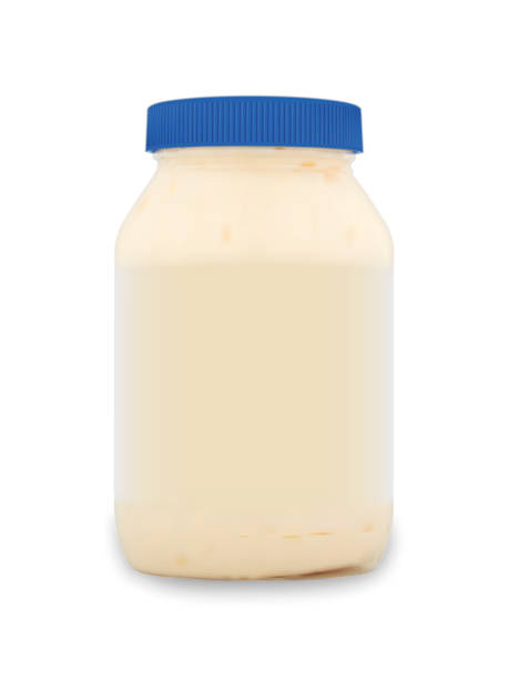 istock Realistic packaging mockup template. Mayonnnaise white sauce in glass jar with blue lid. Vector illustration. 1070114070