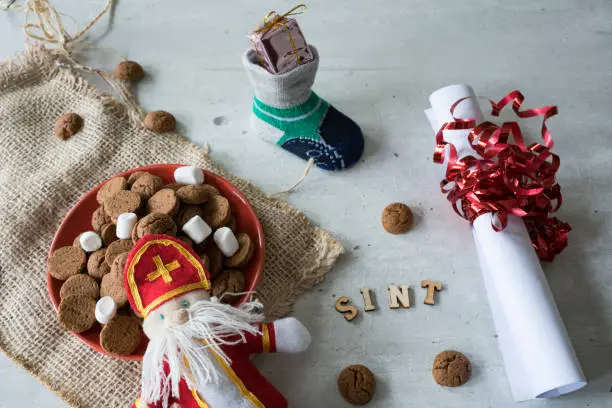 Photo of roll paper, sock and bowl with ginger nuts, kruidnoten, for Sinter event in The netherlands