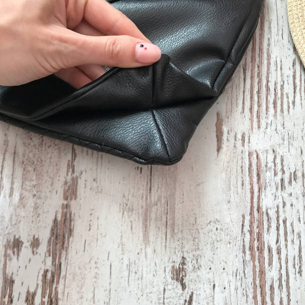 istock Black bag on a wooden background 1070118930
