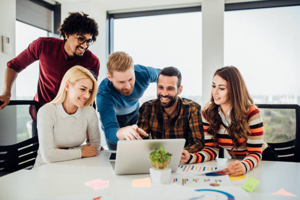istock Happy coworkers using laptop 1070121258