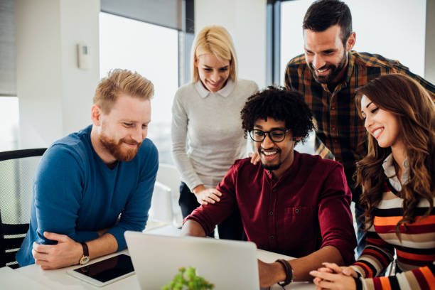 istock Smiling young people with laptop 1070121350
