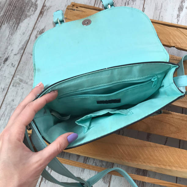 istock Turquoise bag on a wooden background 1070122016