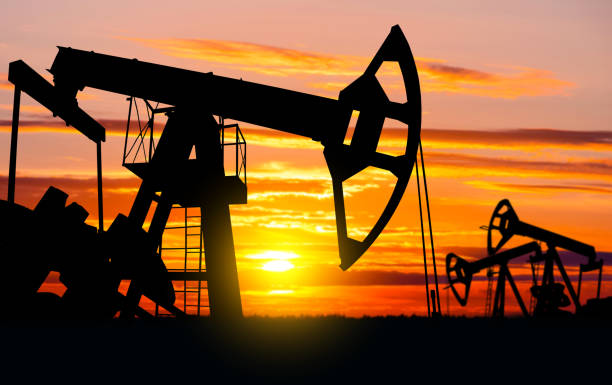 Oil Field. Industrial landscape. Oil pumps against the setting sun. drilling rig stock pictures, royalty-free photos & images